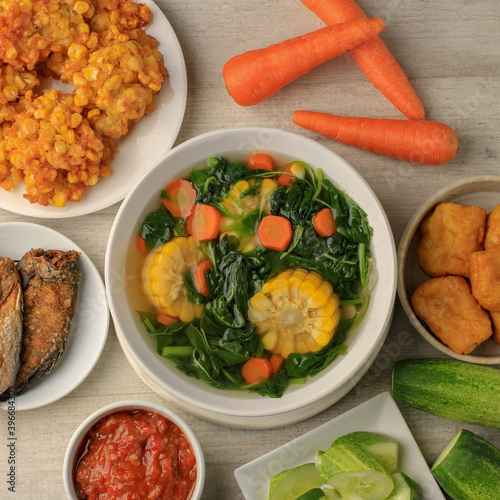 Sayur Bening Bayam is Daily Menu in Indonesian family, made from Spinach, Carrot, and Corn. Spiced with Garlic  and Salt. Served with Various Side Dish like Tofu or Fried Salted Fish and Sambal. photo