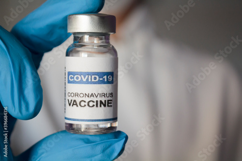 Doctor holding injection vial with Coronavirus or Covid-19 vaccine