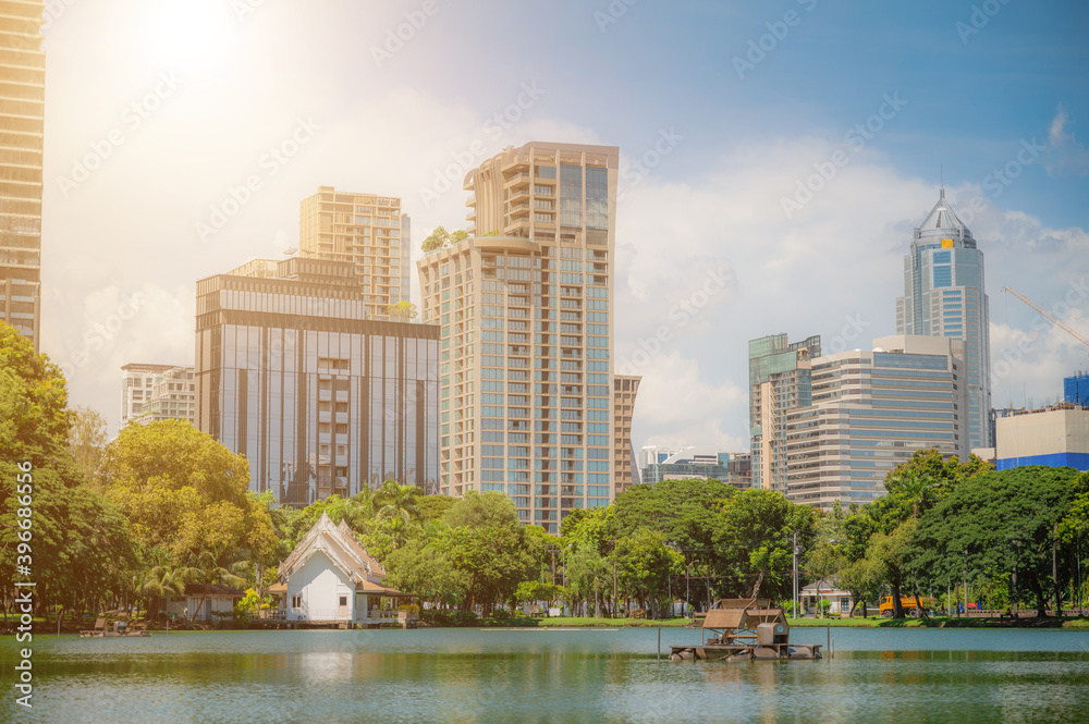 Tall building situated on a lake Rich in trees On a clear day At Lumpini Park, Bangkok, Thailand
