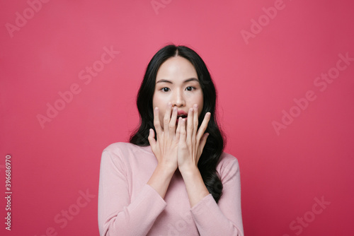 Portrait of asian woman with shocking expression isolate on pink background.