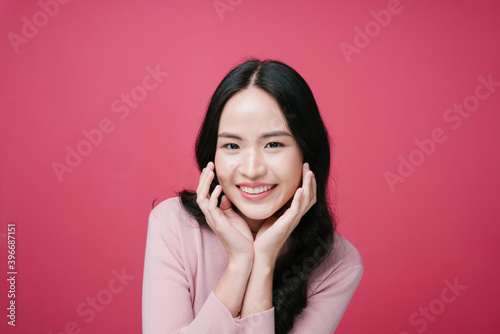 Portrait of happy asian woman isolate on pink background.