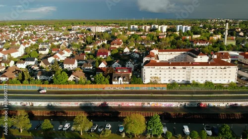 Aerial view overlooking the townscape of the Raunheim town, sunny, summer evening, in Germany - tracking, drone shot photo