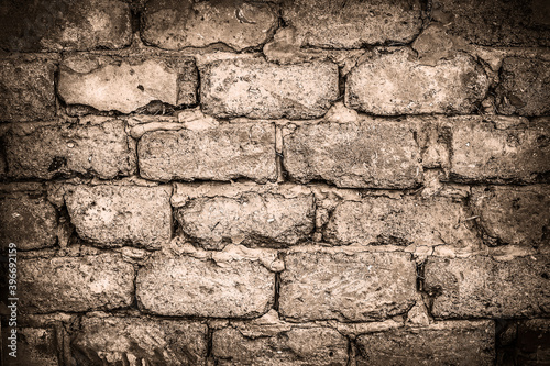 Wall made of big rough concrete blocks as background. Sepia toning.