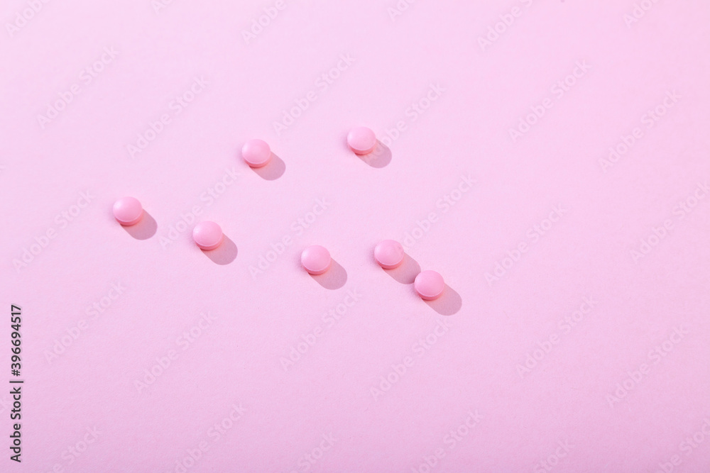 Tablets and pills, vitamins and antibiotic on pink background, copy space Tablets and pills, vitamins and antibiotic on pink background, copy space
