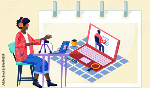 Dark skinned man records a video lesson for a student. A man with headset leads a webinar. Teacher sits at a table with a laptop and speaks into a microphone, online learning modern education