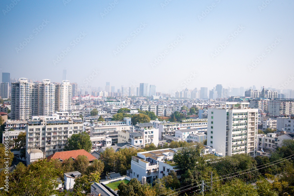 Obraz premium Aerial view of Wuhan city in foggy. Wuhan skyline and Yangtze river with supertall skyscraper under construction in Wuhan Hubei China.