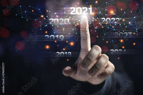 Business people touch 2021 targets for startups and new technology information. There are graphics lines of the network the multimedia information system.