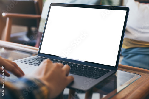 computer blank screen mockup.hand woman work using laptop with white background for advertising,contact business search information on desk at coffee shop.marketing and creative design