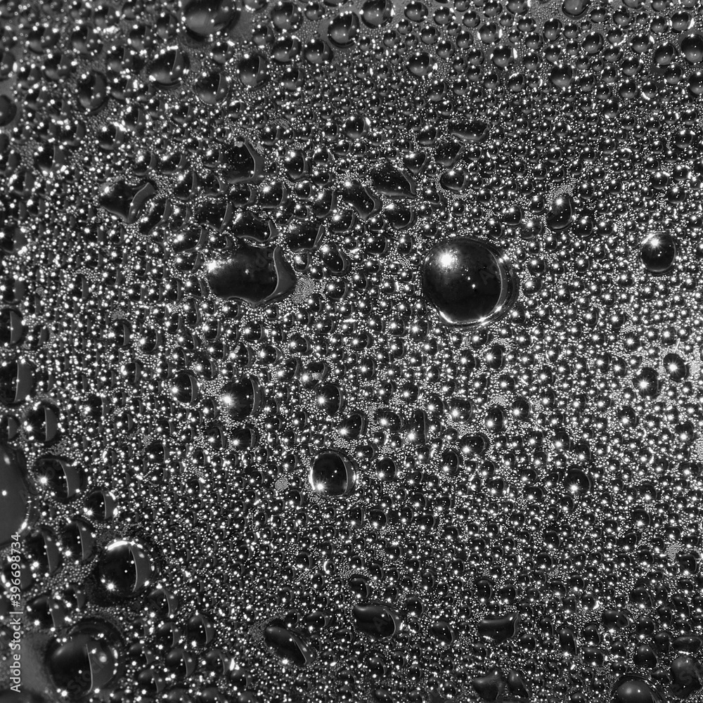 Natural dark silvery black water dew drops texture macro background vertical textured wet vapor bubble splashes pattern copy space silver glossy drop detail large detailed droplet closeup gentle bokeh