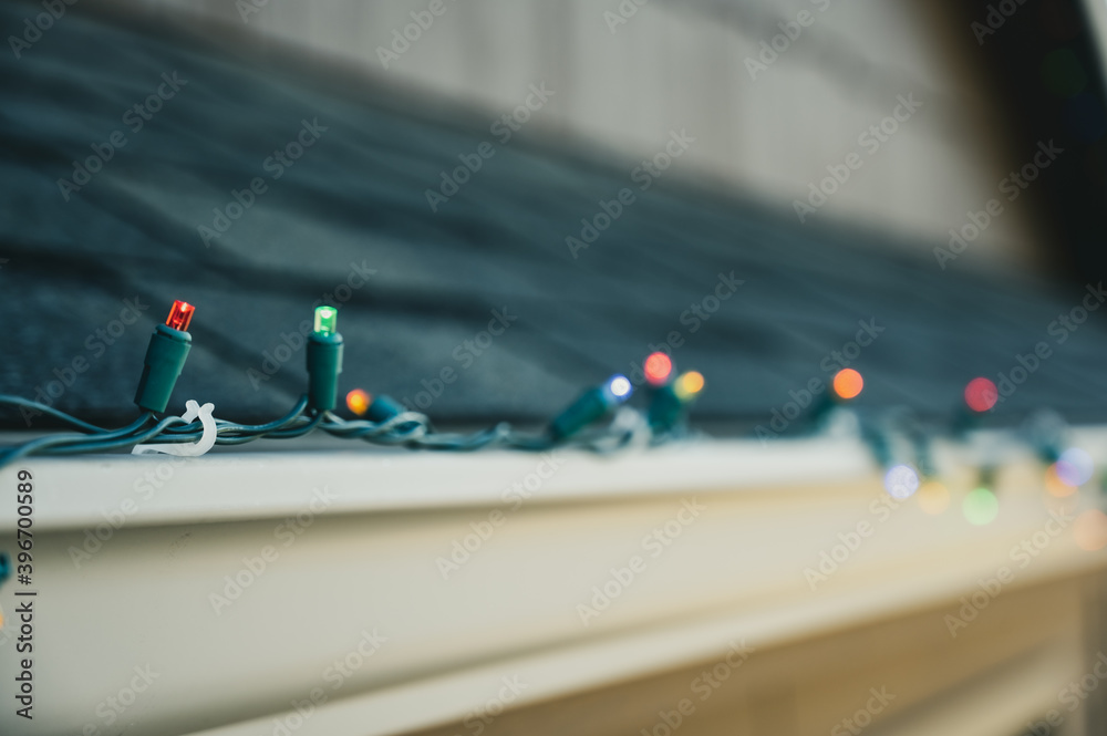 Hanging Christmas lights on gutter with plastic clips StockFoto