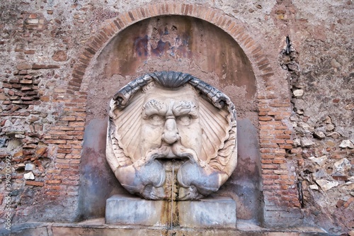 Photography detail of fountain in rome italy, photo as a background in old italian roman cap