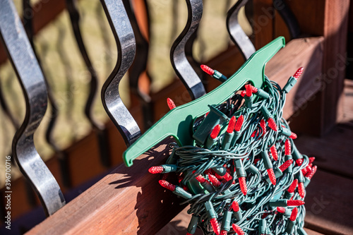 Принти на полотні Selective focus on string of Christmas lights being put onto a wooden outdoor ba
