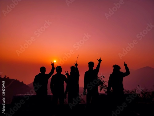 silhouettes of people at sunset