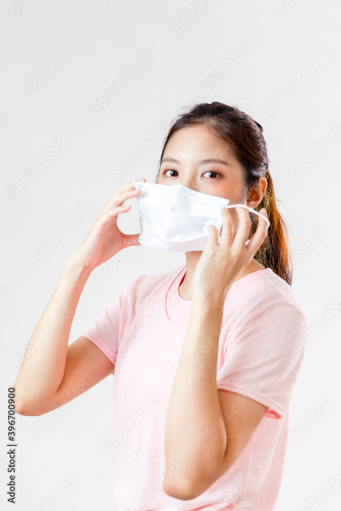 Asia woman wearing an anti virus protection mask to prevent others from corona COVID-19 on white background
Asia woman wearing an anti virus protection mask to prevent others from corona COVID-19 on white background