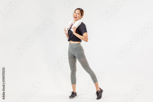 Asian cute women stand on white wall background with copy space.Exercise for Lose weight, increase flexibility and tighten the shape. 