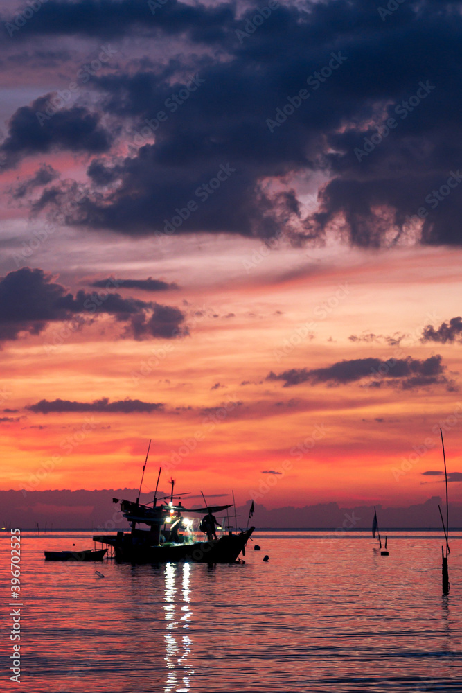 sunset in the sea with fishing boat in thailand