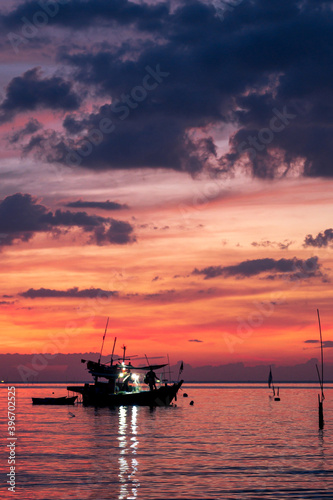 sunset in the sea with fishing boat in thailand