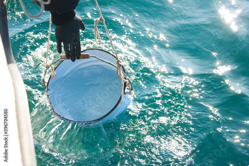 Sampling of sea water. Laboratory dishes on the background of the sea. Marine ecology concept. 