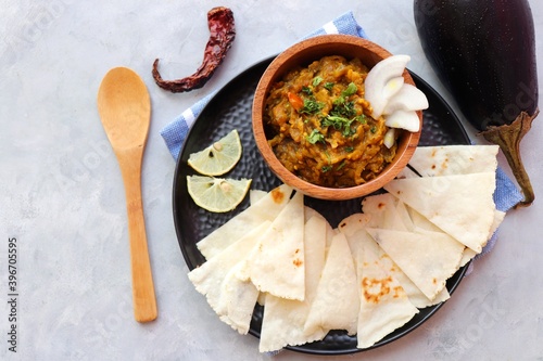 Baigan Bharta, also called Vangyache Bharit in Marathi. It is a roasted eggplant curry. Brinjal chutney. served in a wooden bowl with rice roti or tandalachi bhakri. copy space. photo