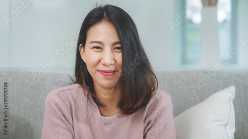 Teenager Asian woman feeling happy smiling and looking to camera while relax in living room at home. Lifestyle beautiful Asian young female using relax time at home concept. Free Download Teenager Asian woman feeling happy smiling and looking to camera while relax in living room at home. Lifestyle beautiful Asian young female using relax time at home concept. - GFXLoad