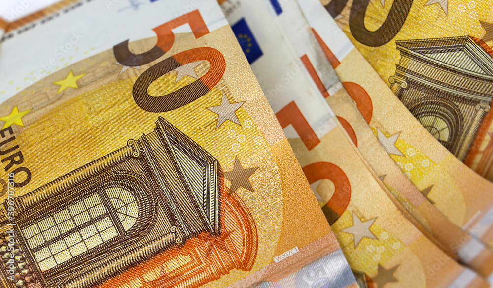 Background of paper money with a face value of 50 euros close-up. The view from the top. Background of paper money with a face value of 50 euros close-up. The view from the top.