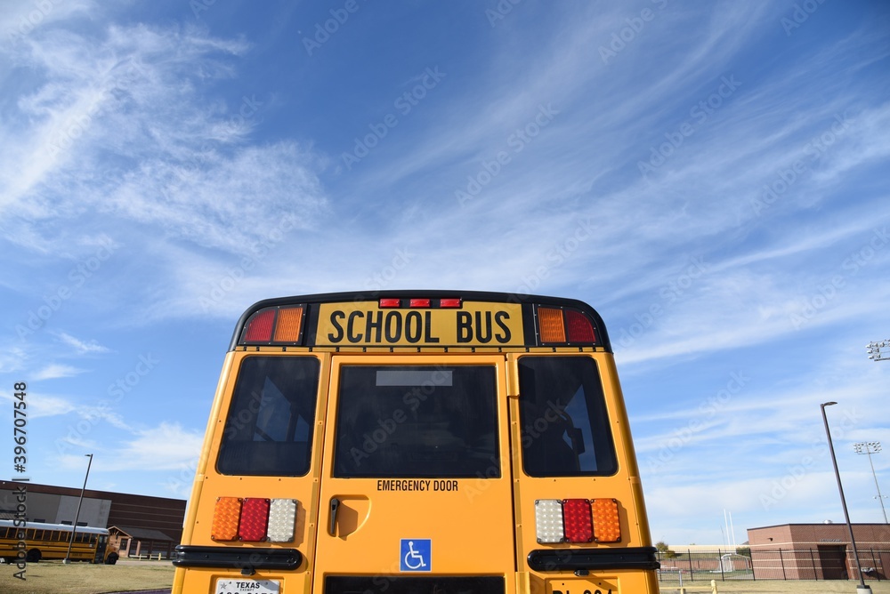 School bus closeup on the beautiful blue sky background