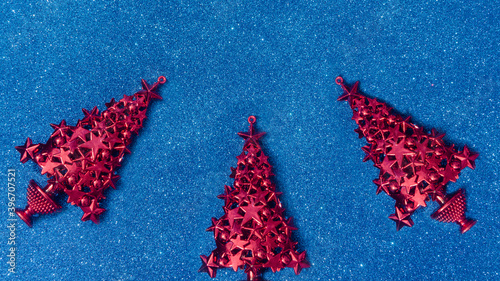 Toy Christmas tree on a blue glitter background. New Year's template. View from above