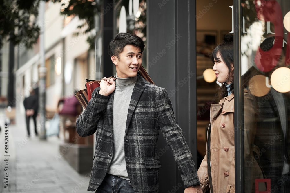 young asian couple shopping in the city