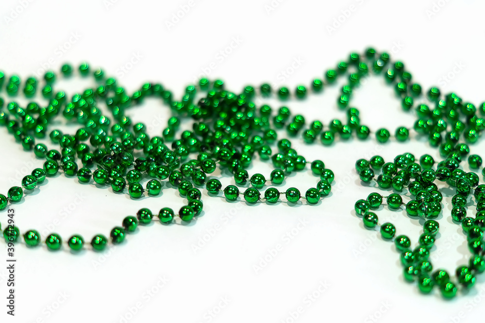 Decorative Christmas green beads for Christmas tree close-up on a white background. Beautiful green beads. Holiday decorations