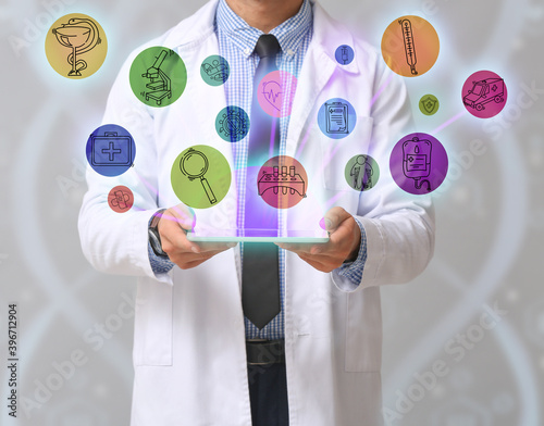 Male doctor with tablet com...