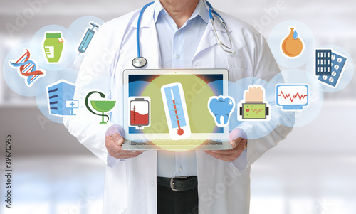 Male doctor with laptop in ...
