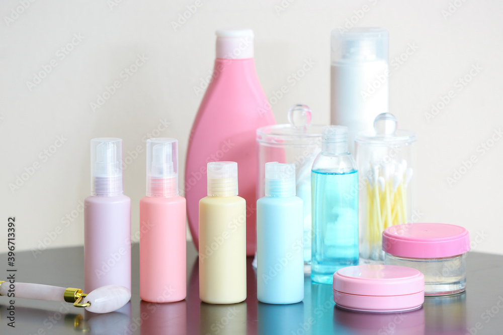 Travel cosmetics kit and quartz face roller on table Travel cosmetics kit and quartz face roller on table