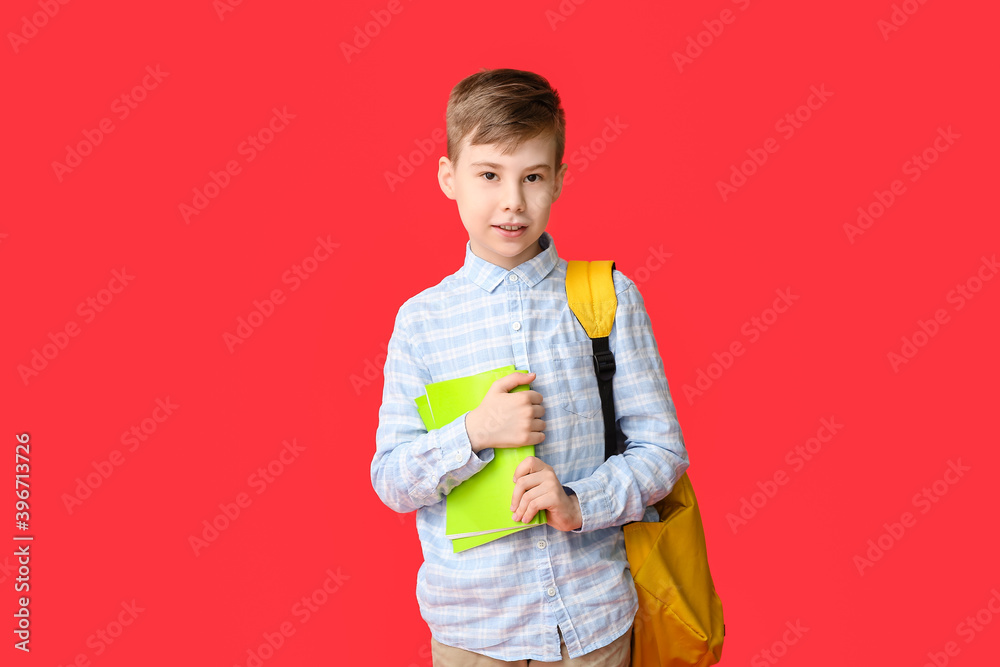 Cute schoolboy with backpack on color background Cute schoolboy with backpack on color background