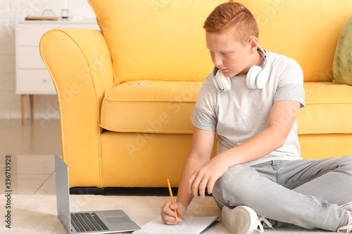 Teenage boy doing homework ...