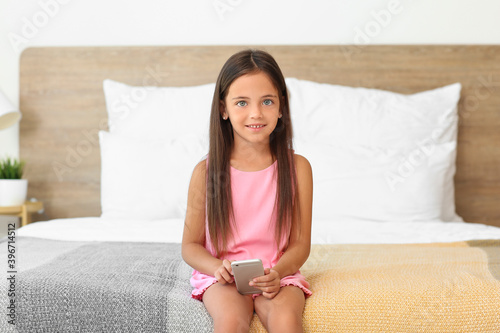 Cute little girl with mobil...