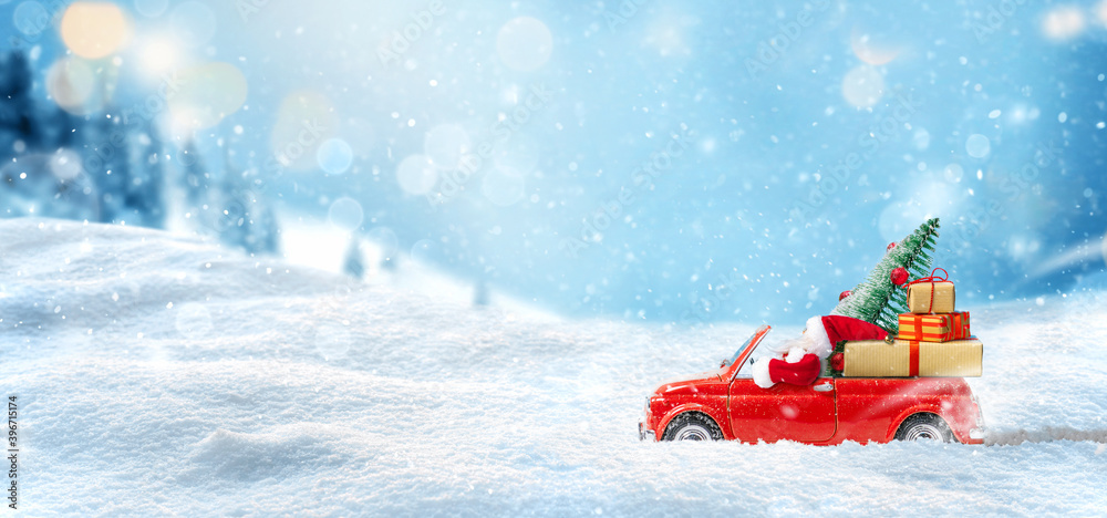 Santa Claus in Red car delivering christmas tree and gifts at snowy background. Christmas card Santa Claus in Red car delivering christmas tree and gifts at snowy background. Christmas card