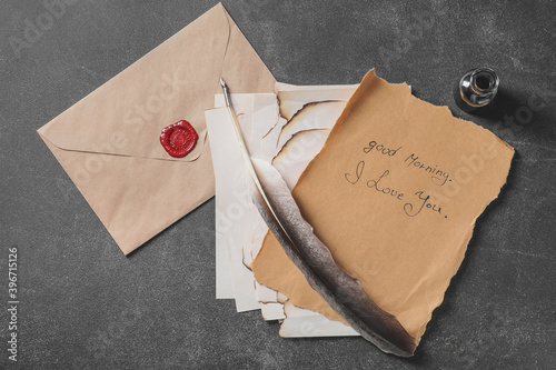 Vintage letter and envelope with feather pen on table