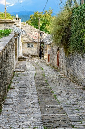 Traditional architecture with  narrow  street and stone buildings a in Vitsa village  central Zagori Greece