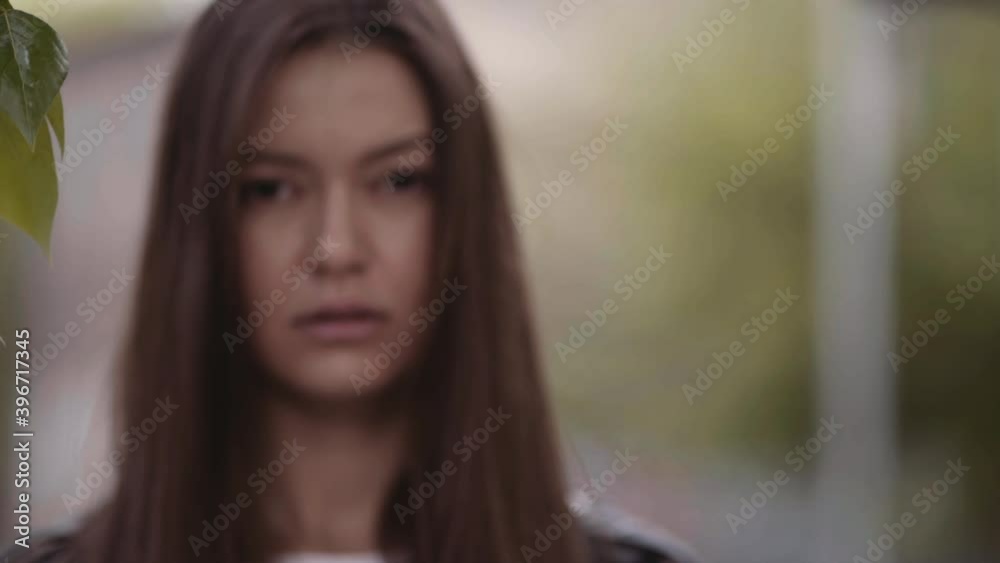 female portrait on a blurred background. calm look of a girl looking at the camera female portrait on a blurred background. calm look of a girl looking at the camera