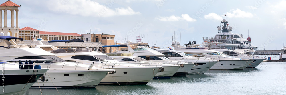 Fototapeta premium Speed boats at harbor. Power boats moored in marina. Sea coast pier.