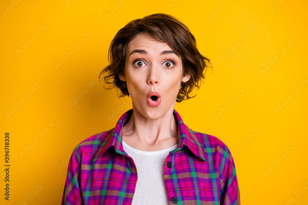 Portrait of surprised charming young woman shocked unbelievable news isolated on shine yellow color background Portrait of surprised charming young woman shocked unbelievable news isolated on shine yellow color background