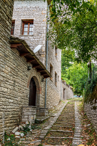 Fototapeta Naklejka Na Ścianę i Meble -  Traditional architecture with  narrow  street and stone buildings a in Vitsa village  central Zagori Greece