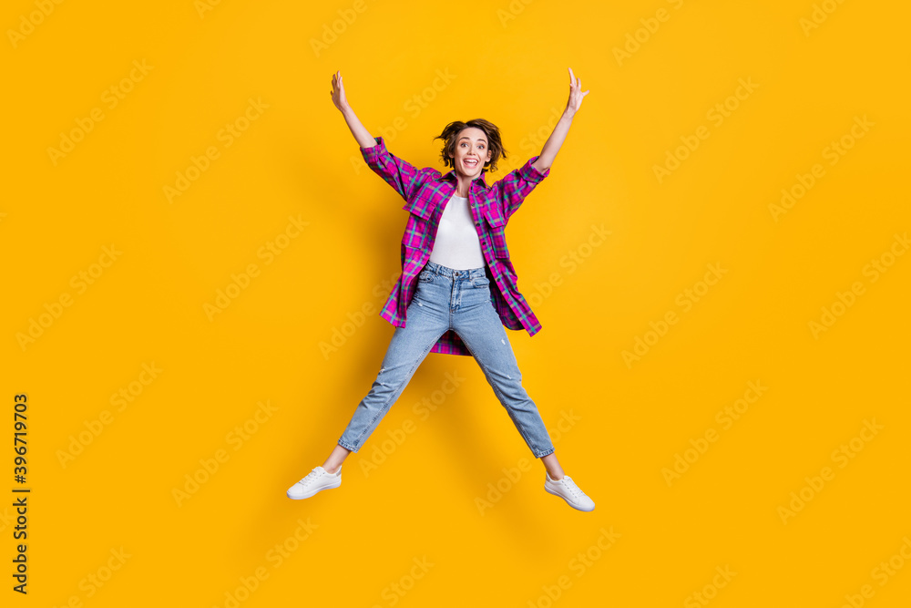 Full size photo of happy cheerful young woman jump air star shape isolated on shine yellow color background