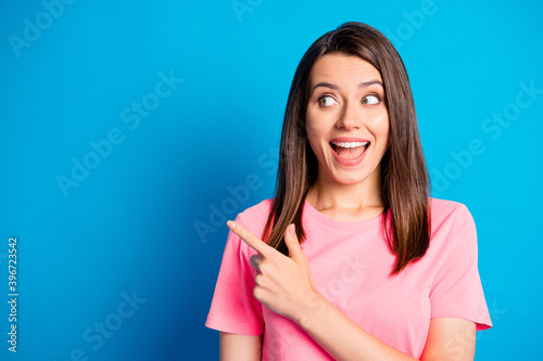 Portrait of astonished charming person direct finger empty space offer banner open mouth isolated on blue color background