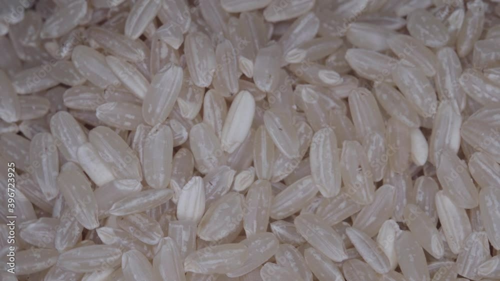 Uncooked dry brown rice extreme close up spinning Uncooked dry brown rice extreme close up spinning