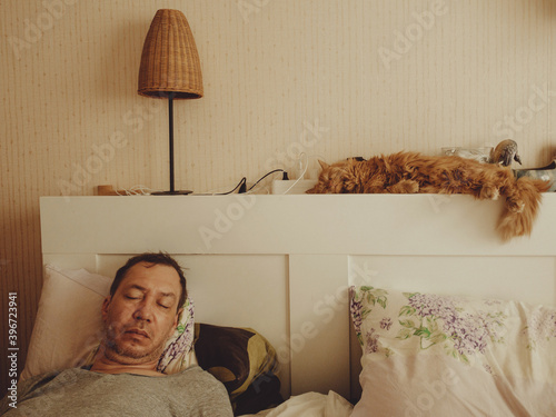 Man sleep at phone in bed.