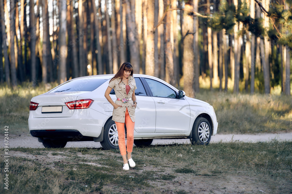 Woman near car on nature in pine forest Woman near car on nature in pine forest