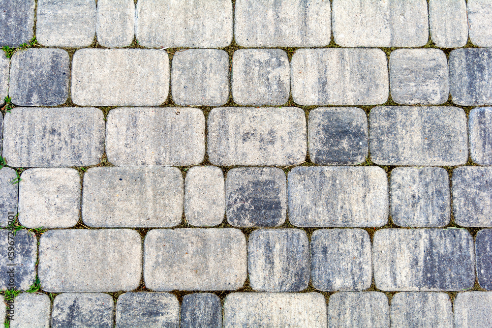 Gray paving slabs for a pedestrian street. Close-up. Texture. Background. Gray paving slabs for a pedestrian street. Close-up. Texture. Background.