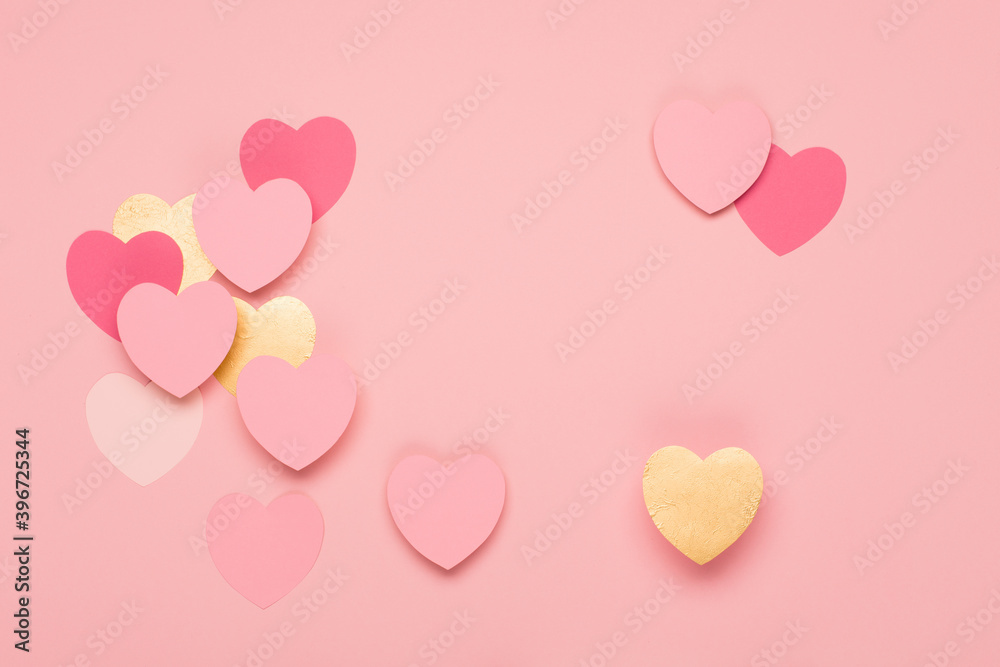 Pink, golden paper hearts on pastel pink background. Festive holiday greeting card for Valentines, Birthday, Woman or Mothers Day.