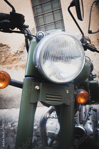 Retro military motorcycle vehicle old fashioned detail light and jandle front view